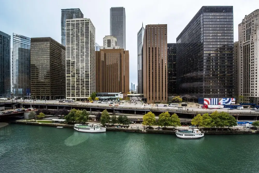 View of the Hyatt Regency Chicago towers from the Chicago River - the hotel complex on the north bank of the river, with tour boats docked at the pier